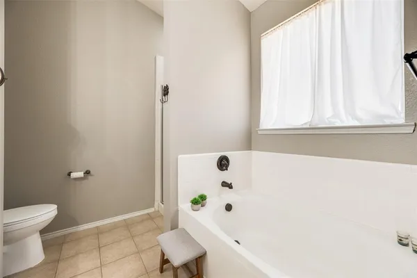 a bathroom with a tub and shower