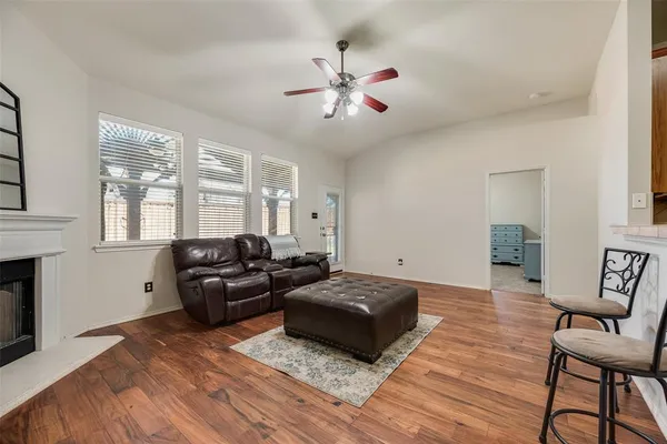 a living room with furniture a flat screen tv and a fireplace