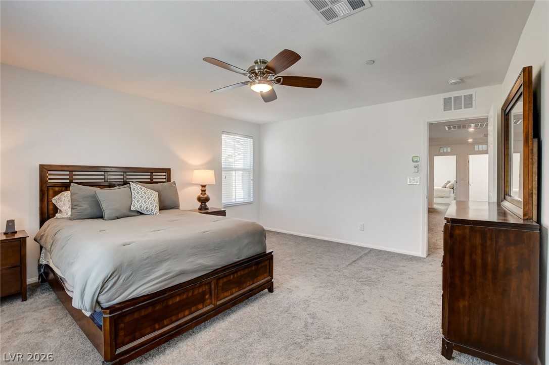 484 Filaree Place Henderson, NV 89015 - Photo 43 of 71 This spacious bedroom offers ample comfort and a welcoming atmosphere.