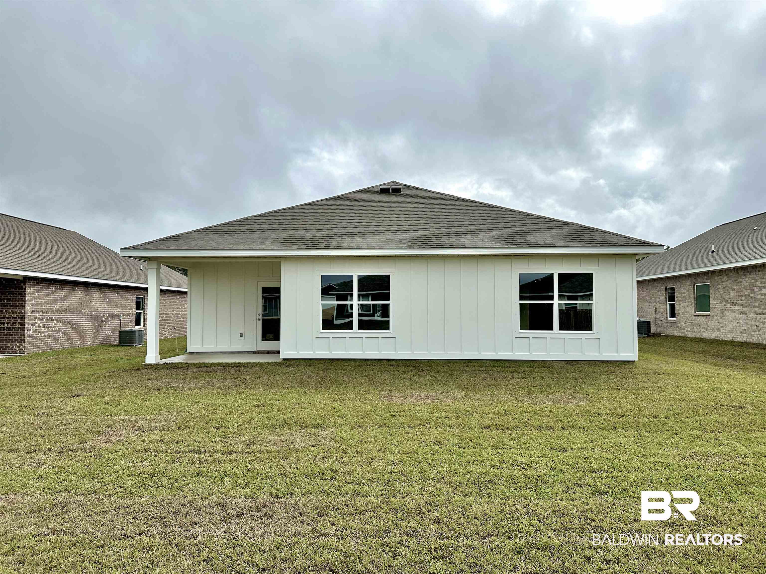 1252 Hayward Loop Foley, AL 36535 - Photo 4 of 44 Rear view of property featuring a lawn