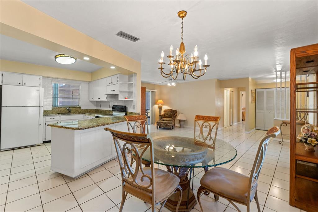 7222 Holiday Drive Spring Hill, FL 34606 - Photo 15 of 50 a view of a dining room with furniture and chandelier