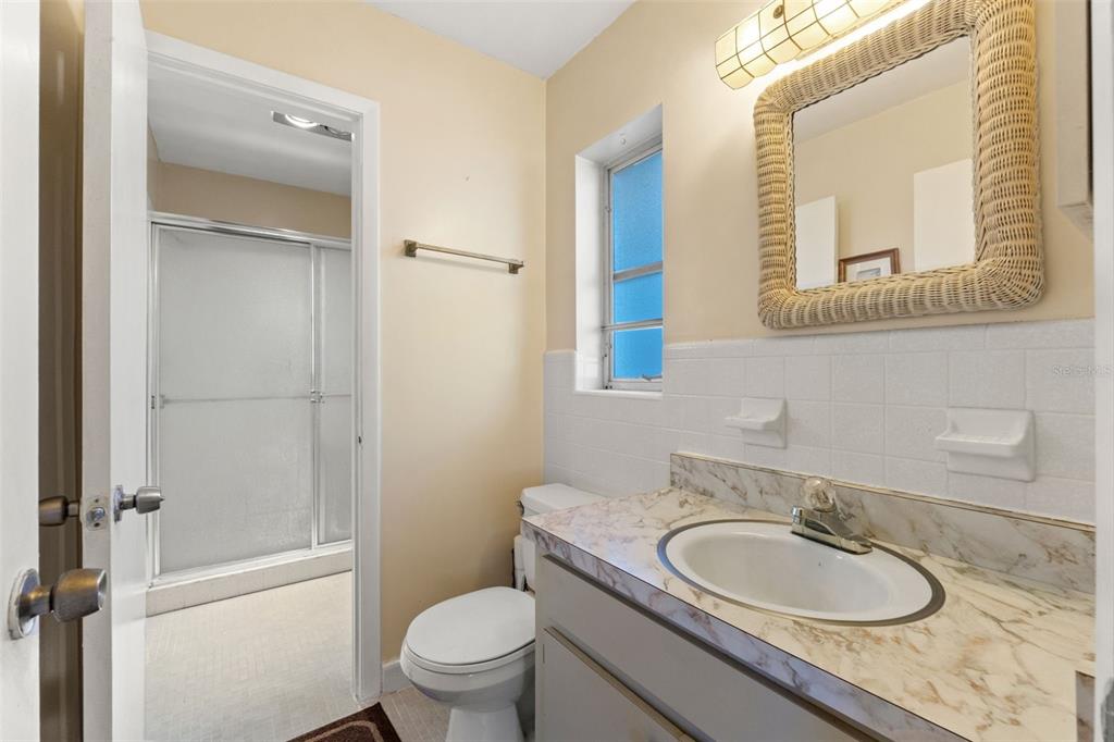 7222 Holiday Drive Spring Hill, FL 34606 - Photo 22 of 50 a bathroom with a granite countertop toilet sink and mirror