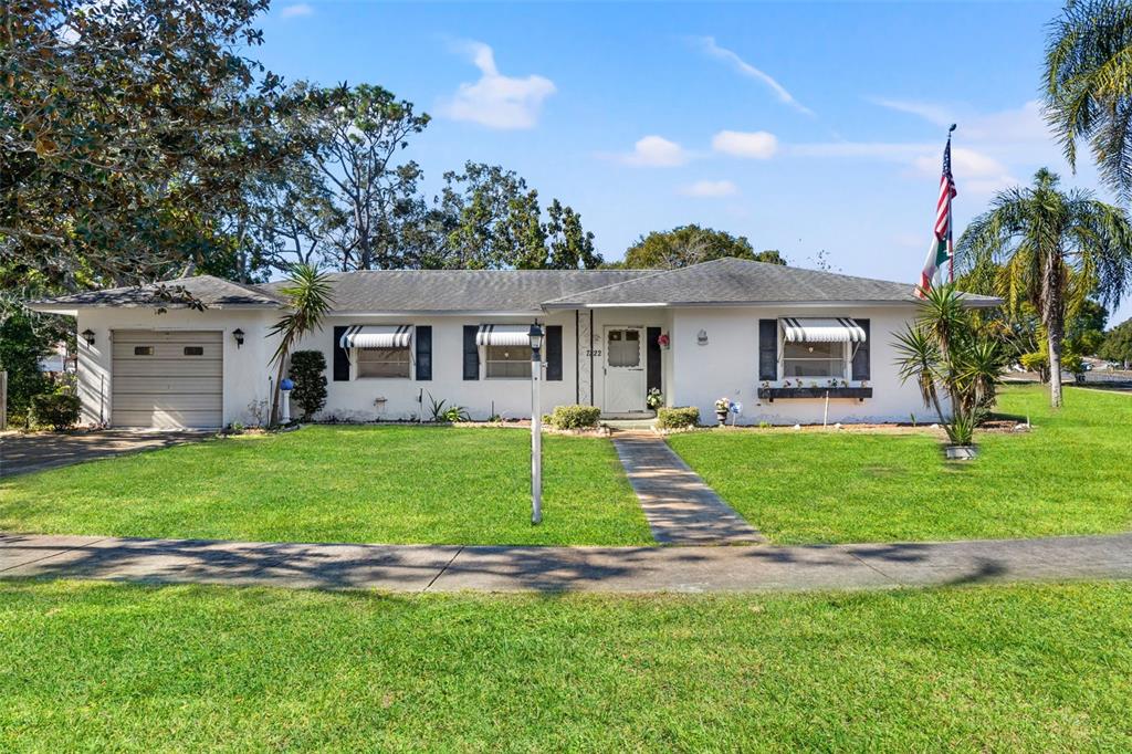 7222 Holiday Drive Spring Hill, FL 34606 - Photo 4 of 50 a view of a house with a yard and plants