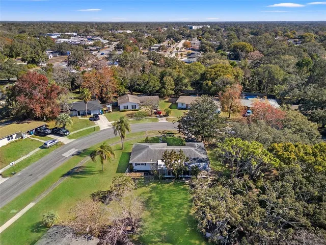 an aerial view of a houses with a yard