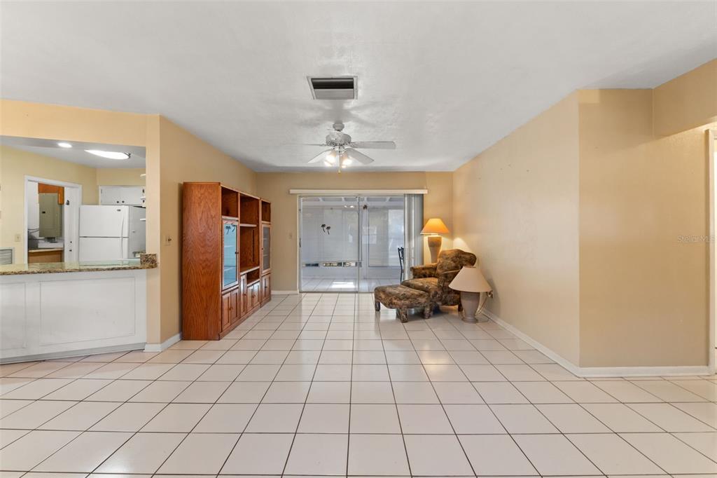7222 Holiday Drive Spring Hill, FL 34606 - Photo 10 of 50 a living room with furniture and a chandelier