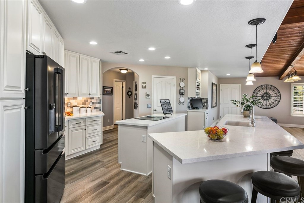 38345 Chaparral Drive Temecula, CA 92592 - Photo 13 of 43 a kitchen that has a sink and a stove with wooden floor