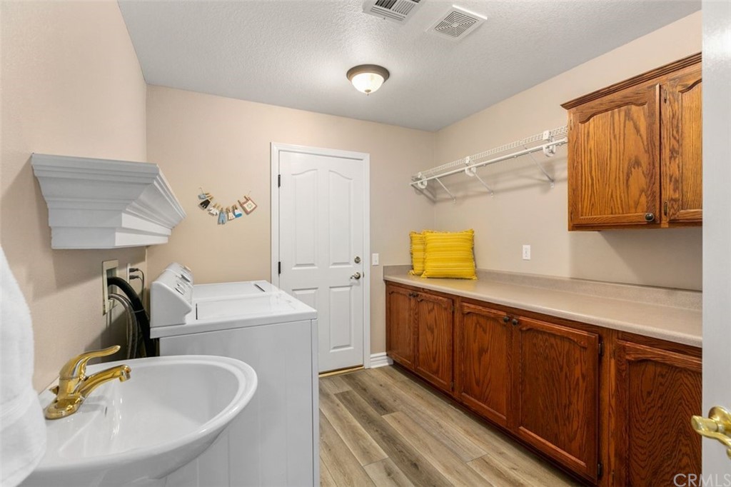 38345 Chaparral Drive Temecula, CA 92592 - Photo 18 of 43 a bedroom with a large bed and a chandelier