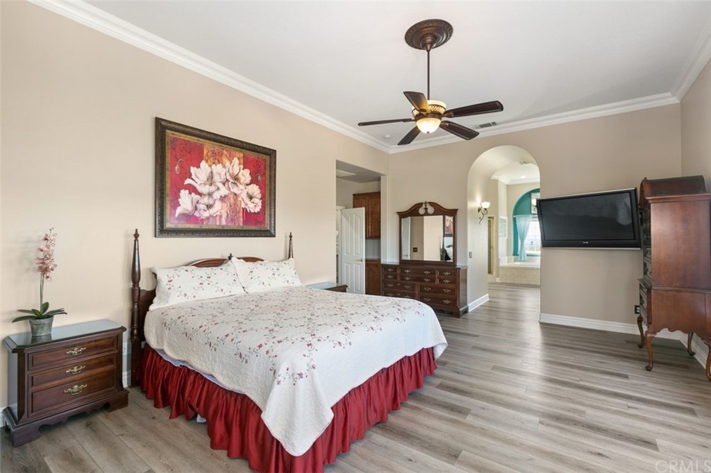 38345 Chaparral Drive Temecula, CA 92592 - Photo 22 of 43 a bedroom with a bed and dresser with mirror