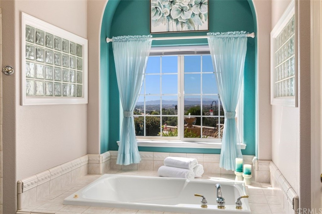 38345 Chaparral Drive Temecula, CA 92592 - Photo 24 of 43 a bathroom with a granite countertop tub a sink and a large mirror