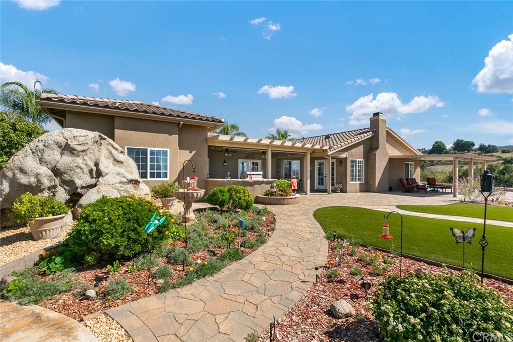 38345 Chaparral Drive Temecula, CA 92592 - Photo 30 of 43 a front view of a house with a yard table and chairs