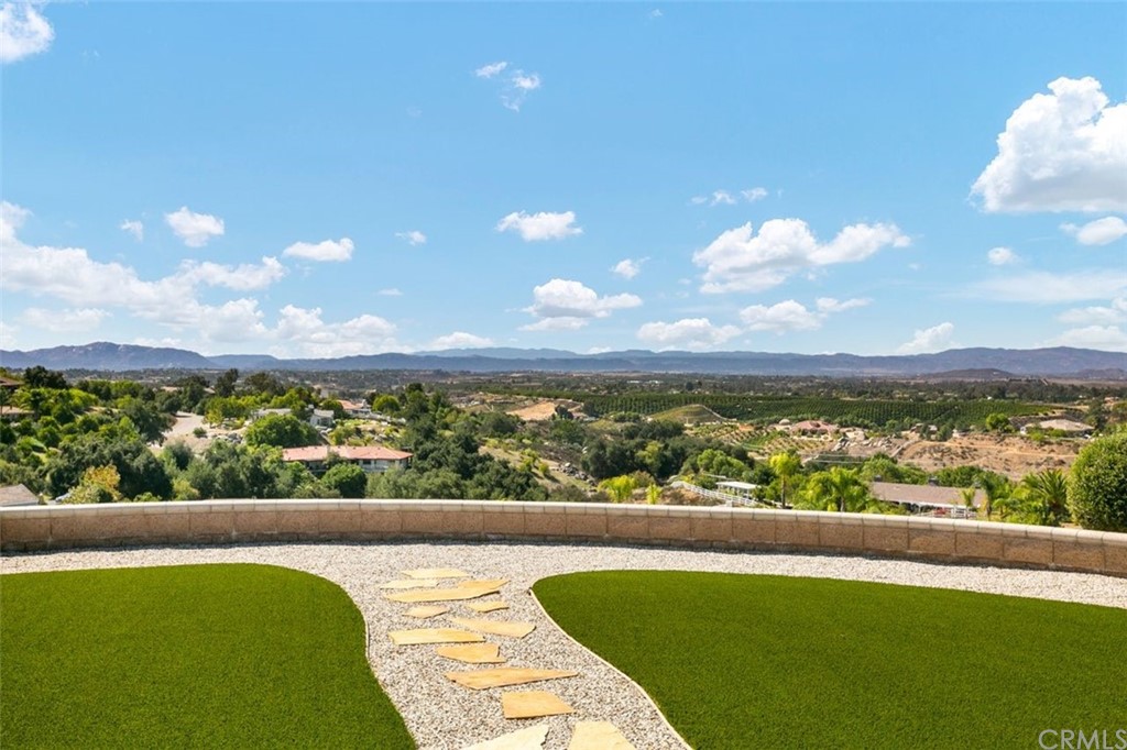 38345 Chaparral Drive Temecula, CA 92592 - Photo 34 of 43 a view of a patio with table and chairs potted plants with wooden floor