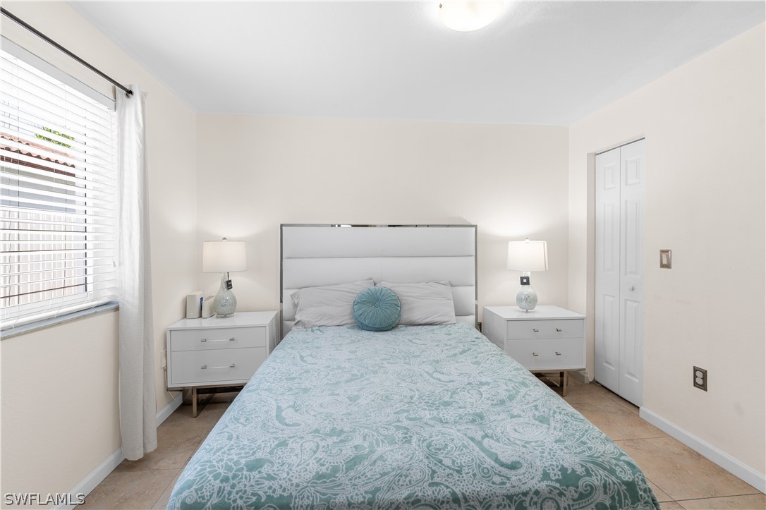 13302 Southwest 283rd Street Homestead, FL 33033 - Photo 14 of 43 a bedroom with a bed and a window