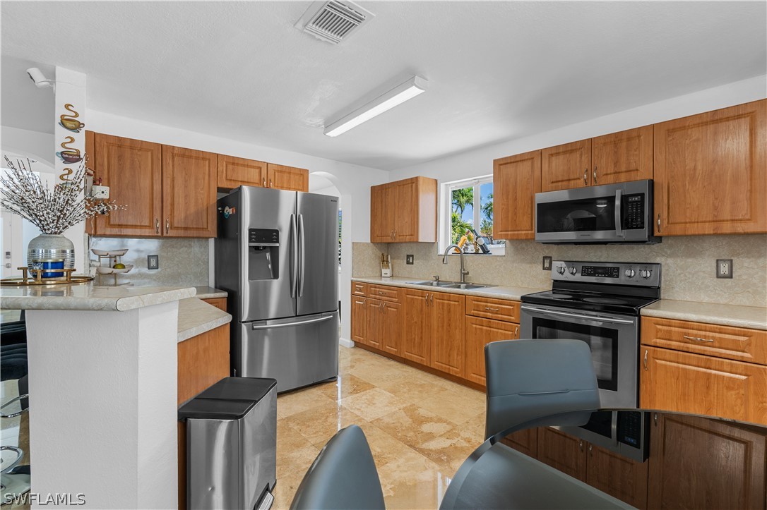 13302 Southwest 283rd Street Homestead, FL 33033 - Photo 18 of 43 a kitchen with stainless steel appliances granite countertop a refrigerator stove microwave and sink