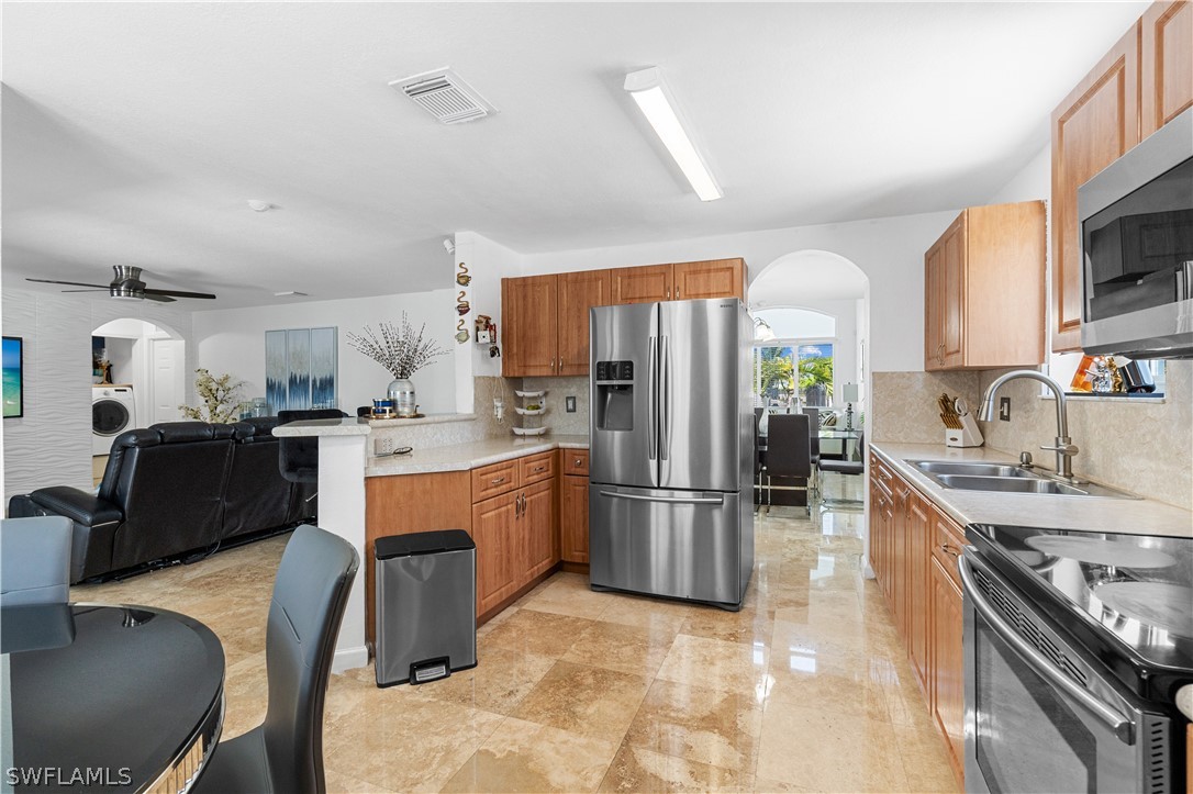13302 Southwest 283rd Street Homestead, FL 33033 - Photo 20 of 43 a kitchen with stainless steel appliances granite countertop a refrigerator stove microwave and sink