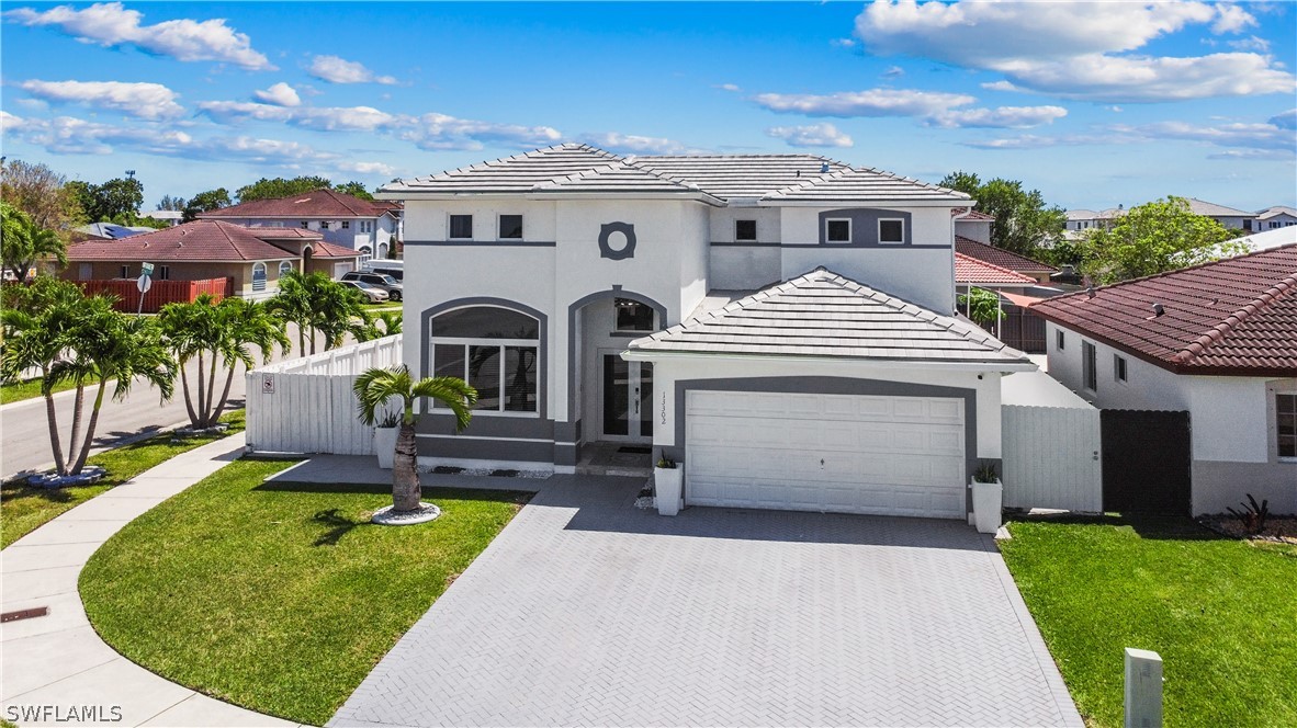 13302 Southwest 283rd Street Homestead, FL 33033 - Photo 2 of 43 a front view of a house with a garden and outdoor seating