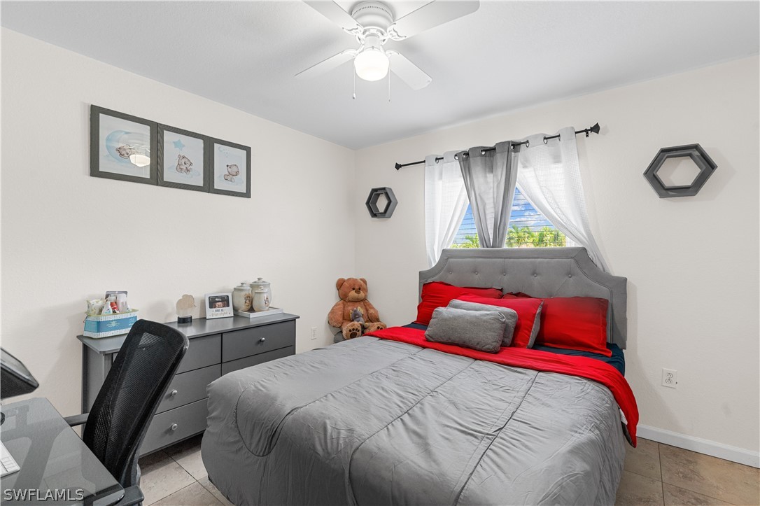 13302 Southwest 283rd Street Homestead, FL 33033 - Photo 25 of 43 a bedroom with a bed and a chandelier