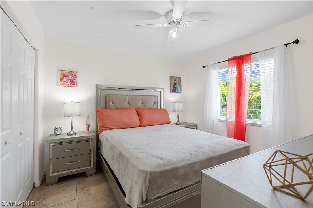 13302 Southwest 283rd Street Homestead, FL 33033 - Photo 26 of 43 a bedroom with a bed and a chandelier