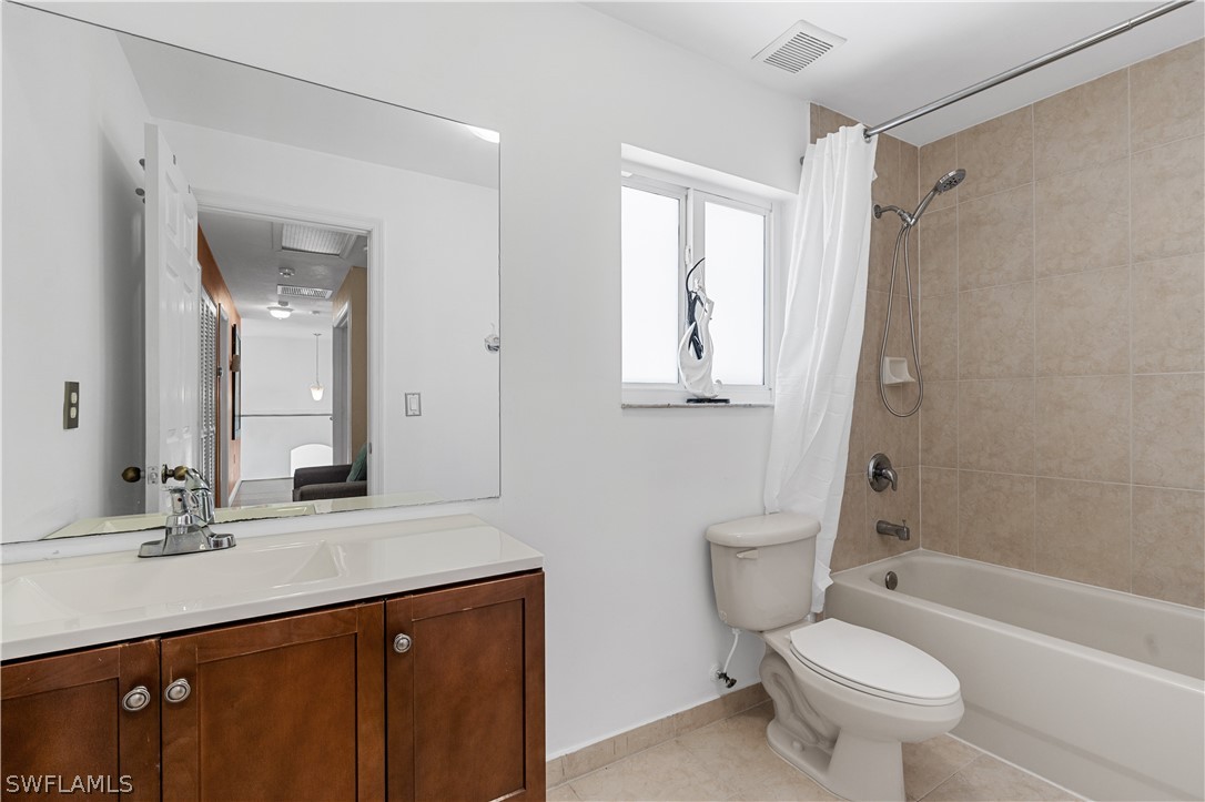 13302 Southwest 283rd Street Homestead, FL 33033 - Photo 27 of 43 a bathroom with a bathtub shower sink vanity mirror and toilet