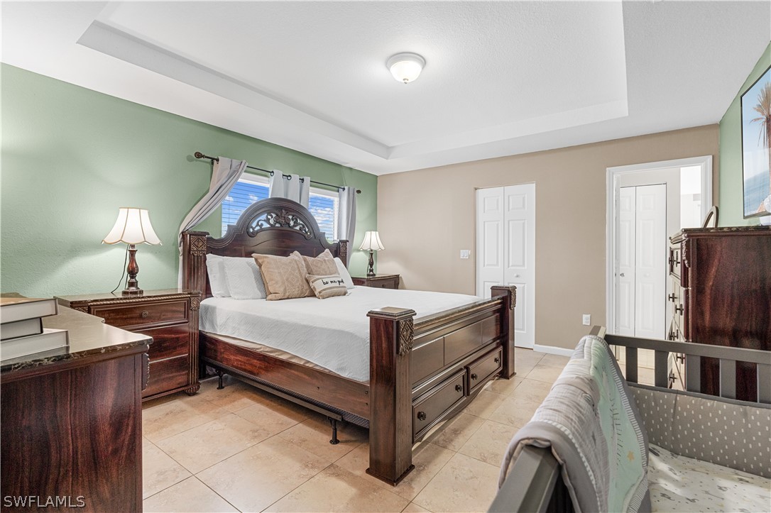 13302 Southwest 283rd Street Homestead, FL 33033 - Photo 28 of 43 a bed room with a bed and a television