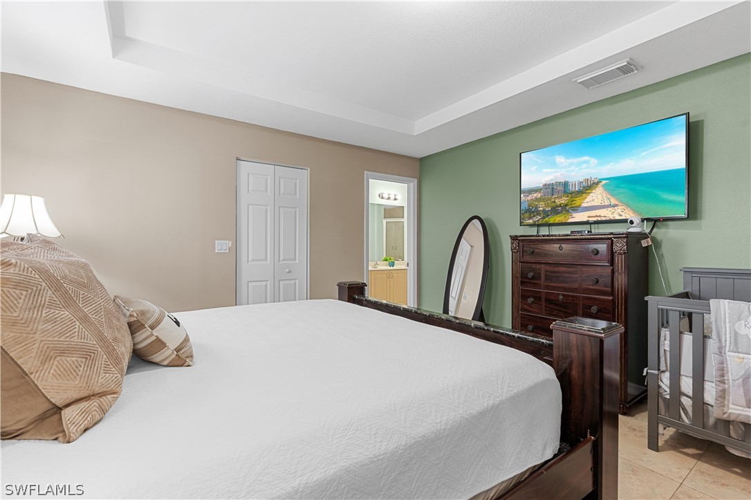 13302 Southwest 283rd Street Homestead, FL 33033 - Photo 29 of 43 a bedroom with a bed and a flat screen tv