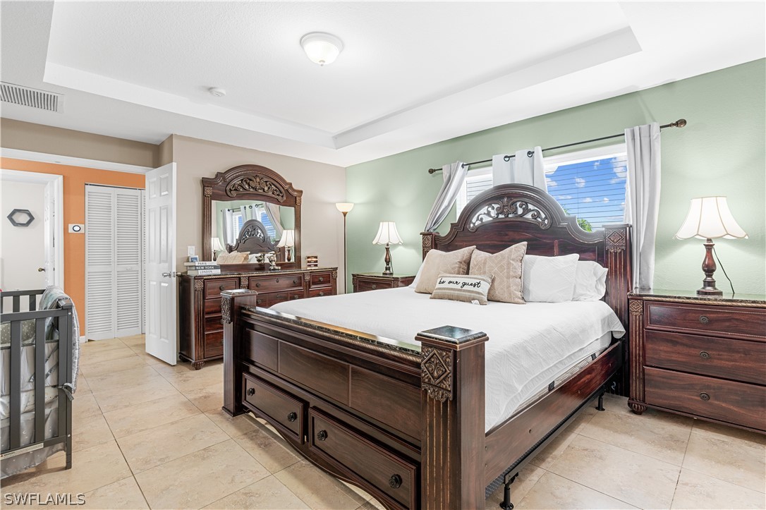 13302 Southwest 283rd Street Homestead, FL 33033 - Photo 30 of 43 a bedroom with a bed and a dresser