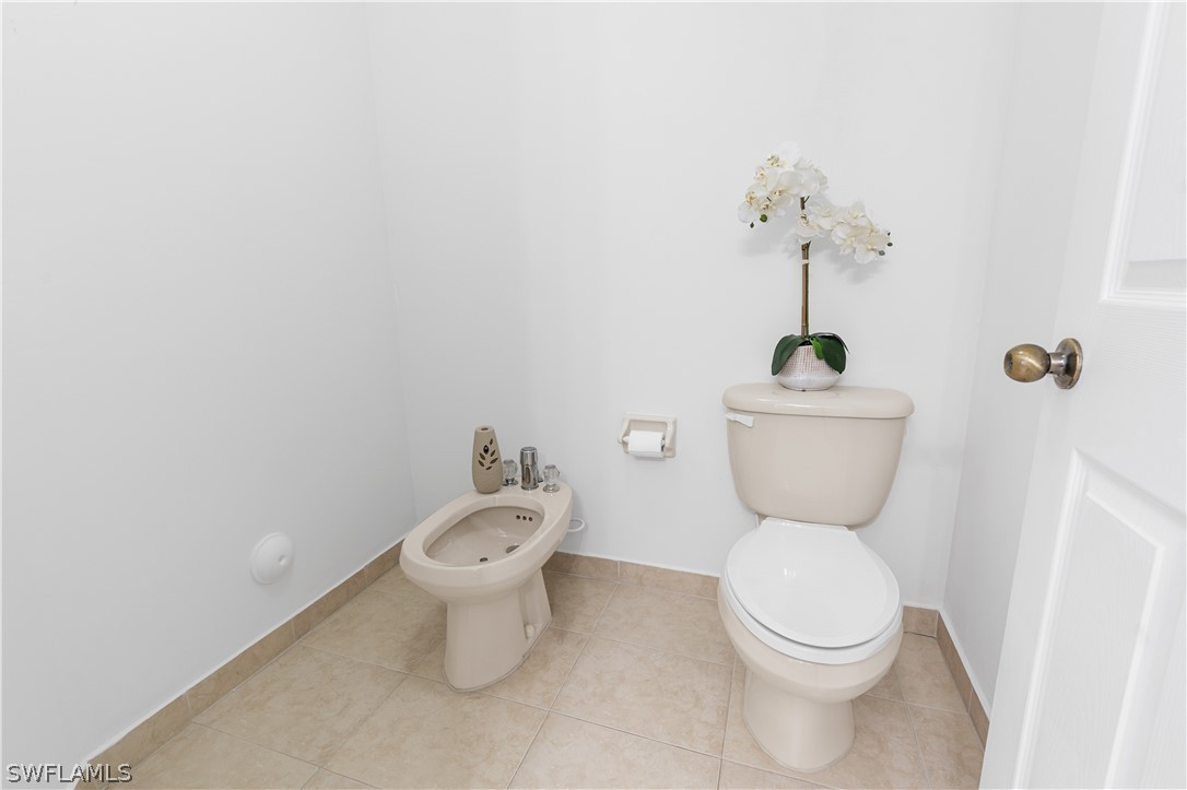 13302 Southwest 283rd Street Homestead, FL 33033 - Photo 32 of 43 a white toilet sitting next to a bathroom sink