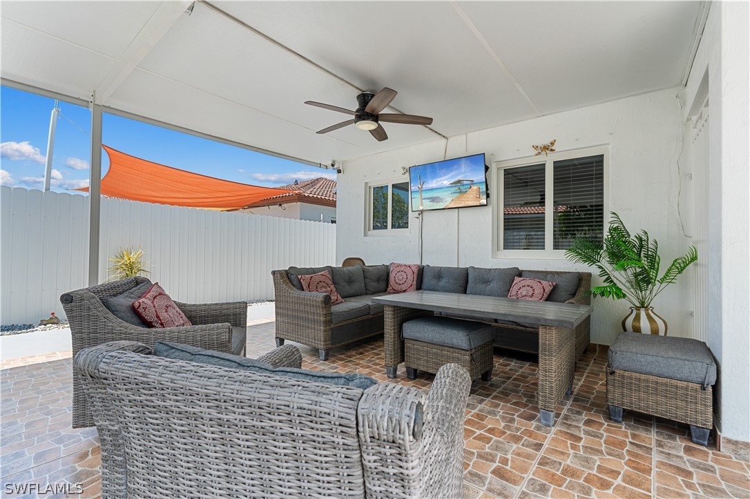 13302 Southwest 283rd Street Homestead, FL 33033 - Photo 37 of 43 a living room with furniture a chandelier and a rug