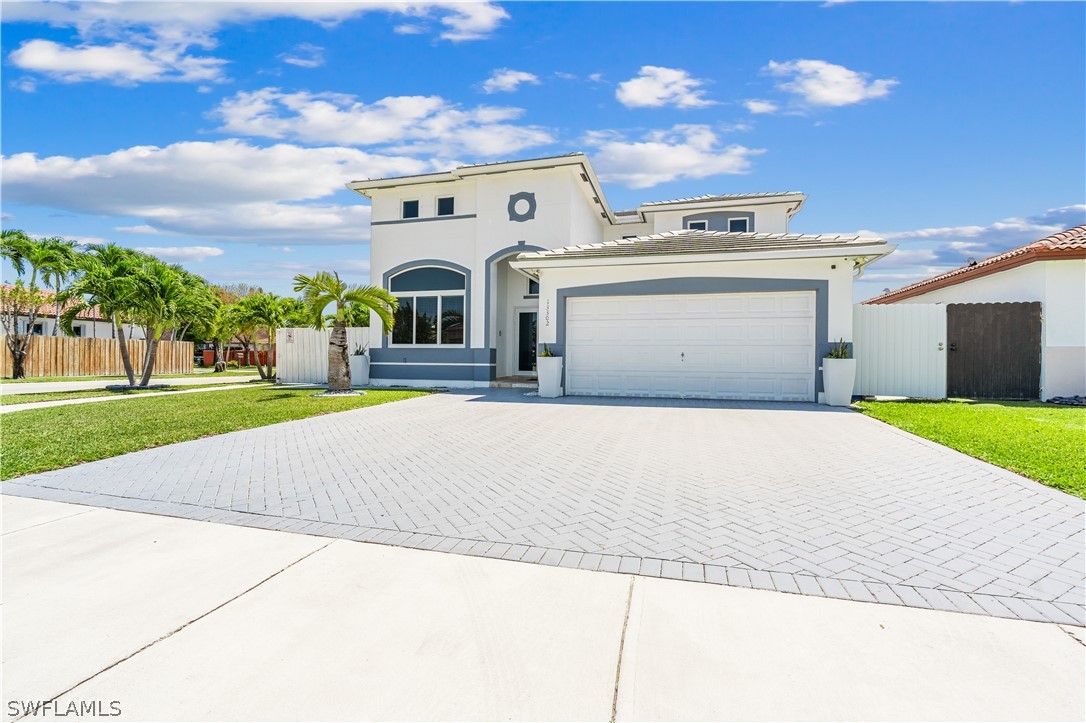 13302 Southwest 283rd Street Homestead, FL 33033 - Photo 43 of 43 a front view of a house with a yard and garage