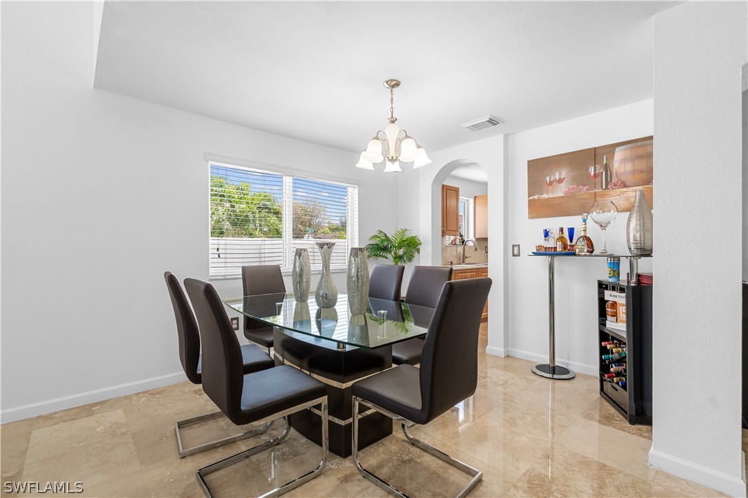 13302 Southwest 283rd Street Homestead, FL 33033 - Photo 7 of 43 a view of a dining room with furniture and chandelier