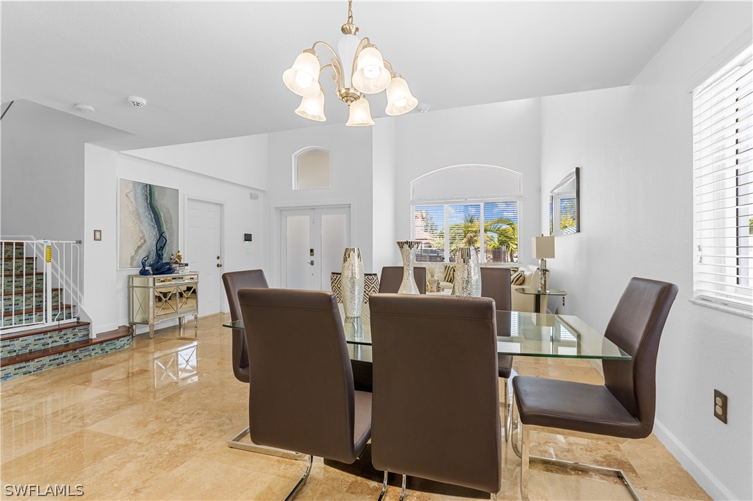 13302 Southwest 283rd Street Homestead, FL 33033 - Photo 8 of 43 a dining room with furniture a chandelier and wooden floor