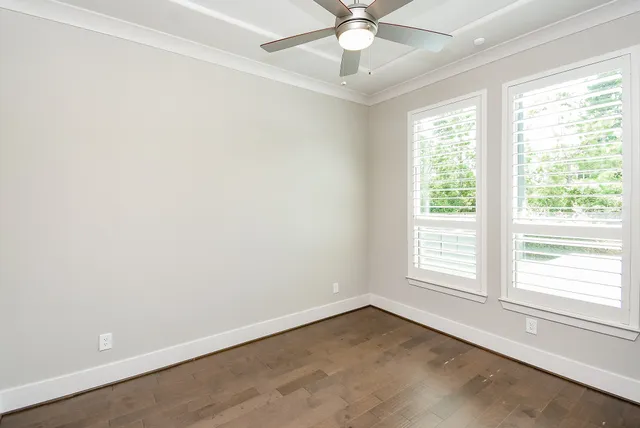 a view of an empty room with a fireplace and a window