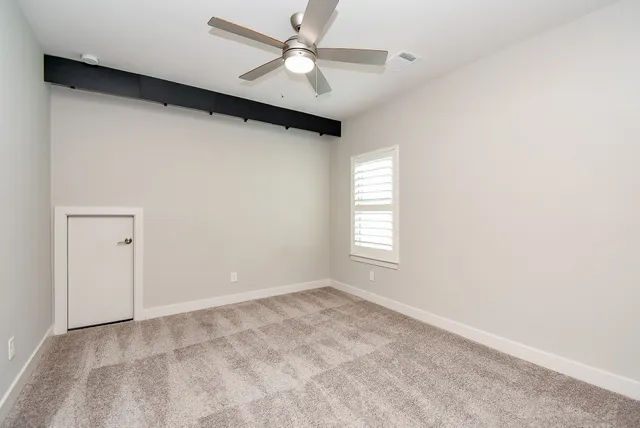 a view of a livingroom with a ceiling fan and window