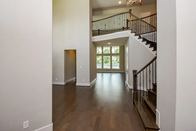 a view of front door with wooden floor and stairs