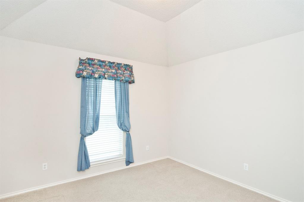7757 Lancelot Road Frisco, TX 75035 - Photo 26 of 27 Empty room featuring light carpet, baseboards, and vaulted ceiling