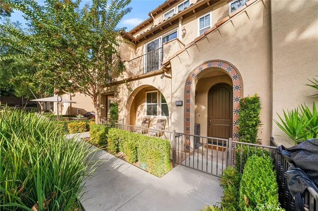 a view of entrance gate of a house with wooden fence