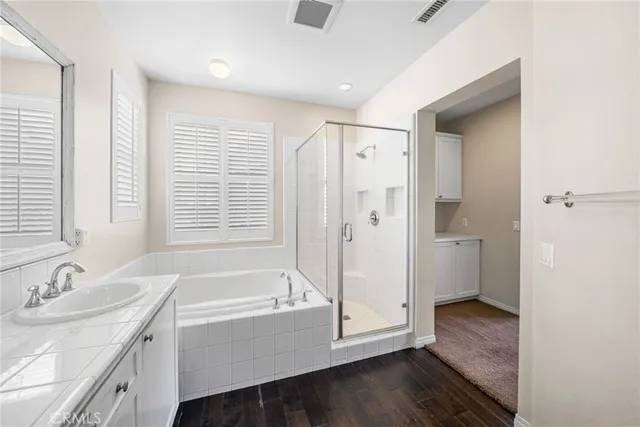 a bathroom with a granite countertop sink and a bathtub