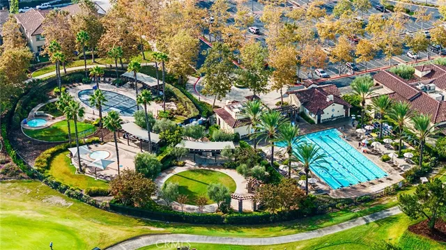an aerial view of residential houses with outdoor space and trees