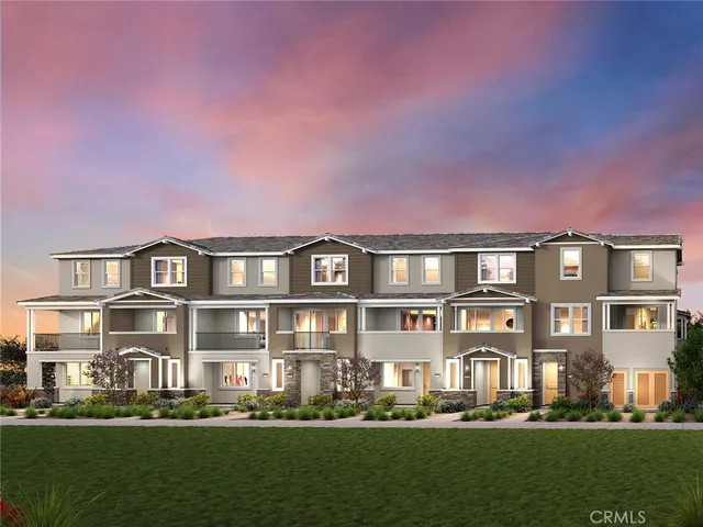 a front view of a residential apartment building with a yard