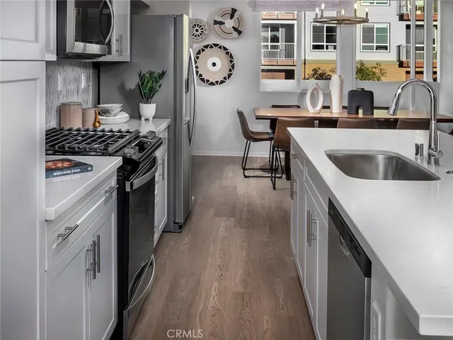 a kitchen with stainless steel appliances granite countertop a stove and a sink