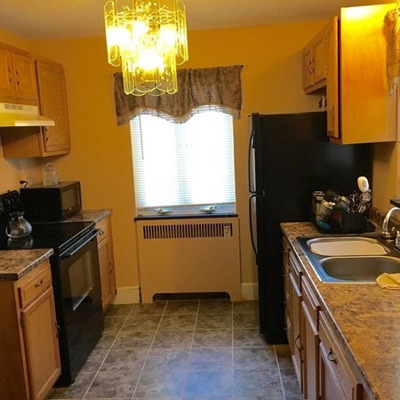 175 Brittany Road Springfield, MA 01151 - Photo 2 of 16 a kitchen that has a sink and a stove