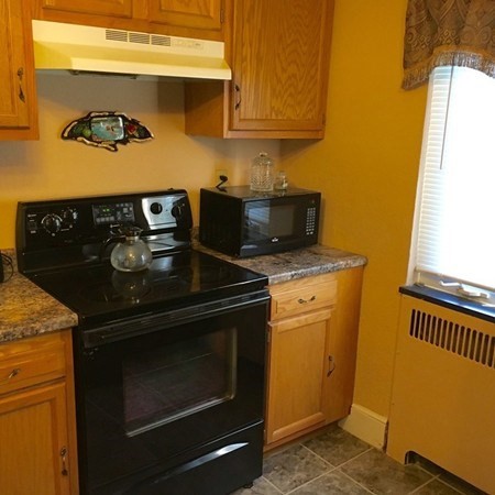 175 Brittany Road Springfield, MA 01151 - Photo 3 of 16 a kitchen with a stove and a microwave