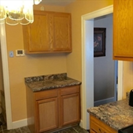 175 Brittany Road Springfield, MA 01151 - Photo 5 of 16 a kitchen with a stove and a refrigerator
