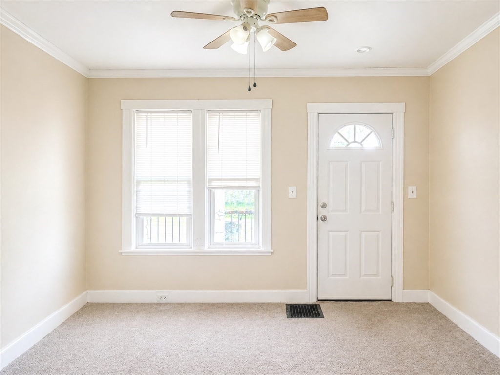 97 Plimpton Street Southbridge, MA 01550 - Photo 12 of 19 an empty room with chandelier fan and windows
