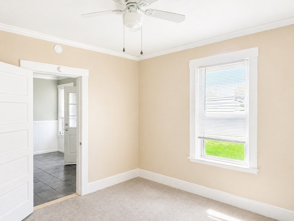97 Plimpton Street Southbridge, MA 01550 - Photo 13 of 19 an empty room with a window and a chandelier fan