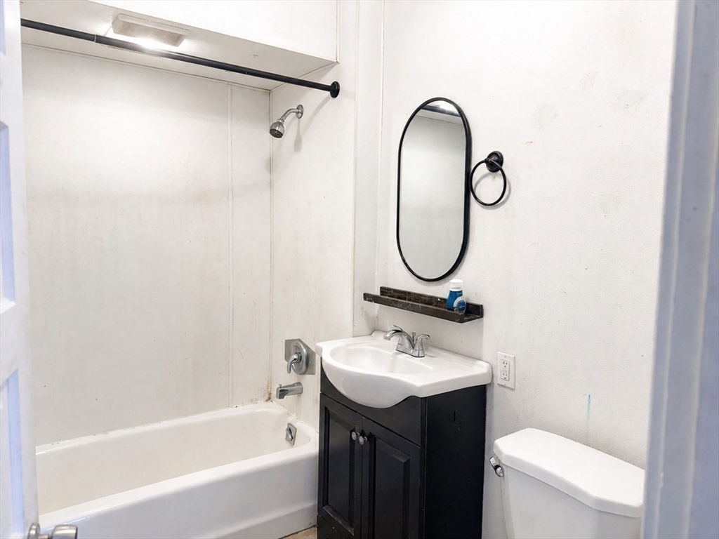 97 Plimpton Street Southbridge, MA 01550 - Photo 17 of 19 a bathroom with a sink and a mirror