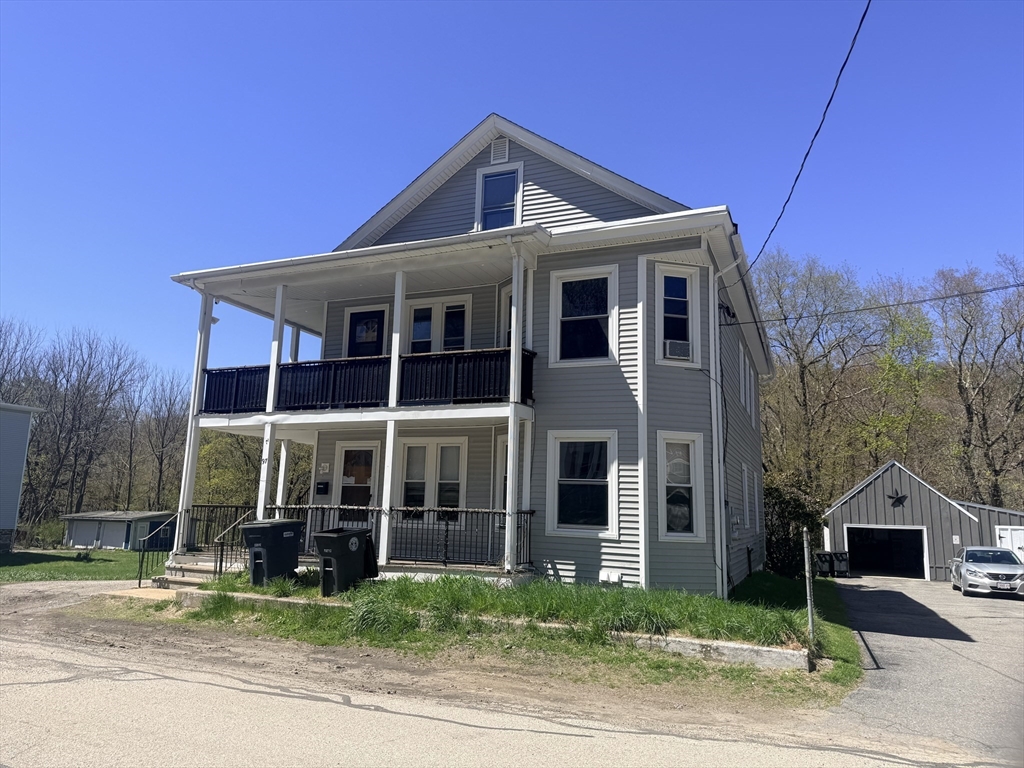 97 Plimpton Street Southbridge, MA 01550 - Photo 2 of 19 a front view of a house with a yard
