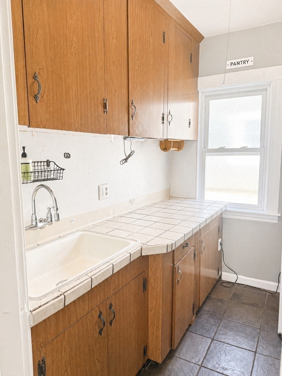 97 Plimpton Street Southbridge, MA 01550 - Photo 10 of 19 a kitchen with granite countertop a sink a stove and cabinets