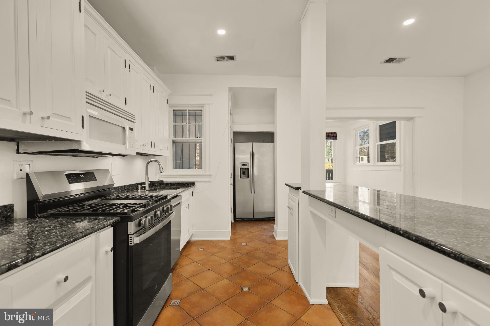38 Sherman Circle Northwest Washington, DC 20011 - Photo 11 of 44 a kitchen with stainless steel appliances granite countertop a sink stove and refrigerator