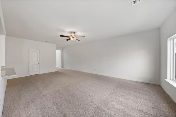 a view of a livingroom and a chandelier fan