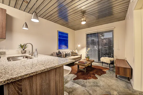 a kitchen with granite countertop a sink stainless steel appliances and cabinets